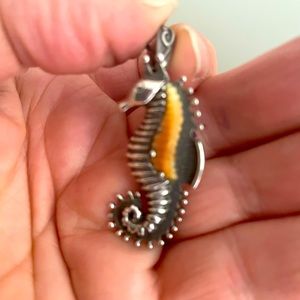 Silver seahorse pendant with fossilized walrus tusk embellishment.